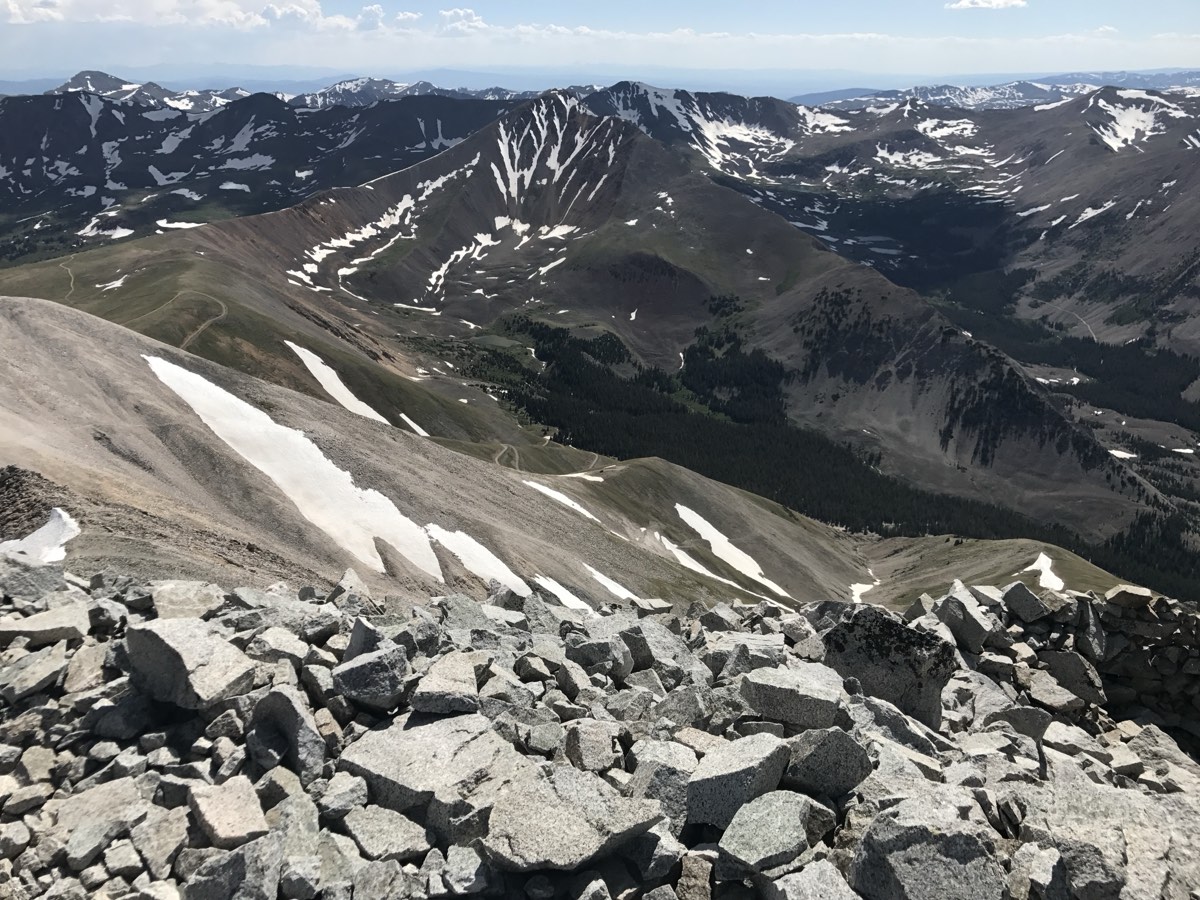 Granite talus on the summit of Mount Antero, looking down the ridge to the 4x4 road switchbacking across the tundra below
